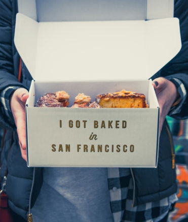 person holding cake in box